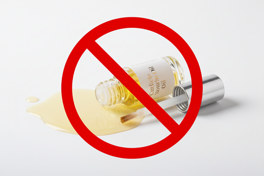 spilled bottle of cuticle oil with a red circle with a line blocking image