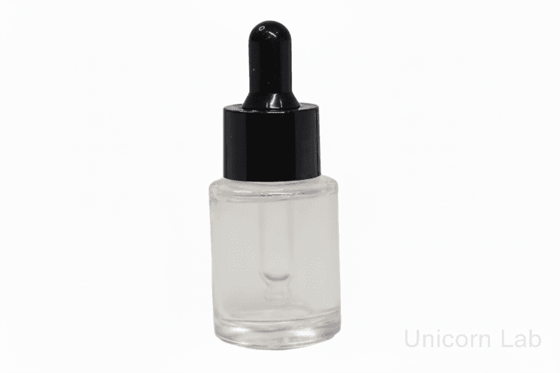Clear 15ml glass flat shoulder dropper bottle with black cap on a white background
