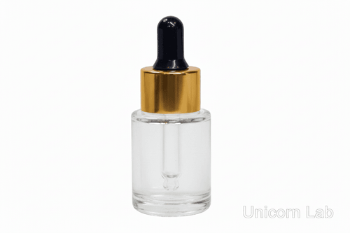 Clear 15ml flat shoulder glass dropper bottle with gold cap on a white background