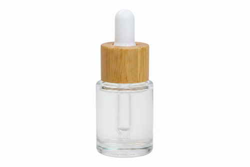 Clear glass dropper bottle with a wooden cap on a white background