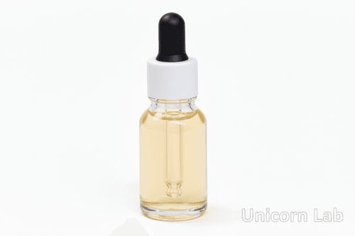 Clear 15ml round bottle with white cap on a white background with cuticle oil inside