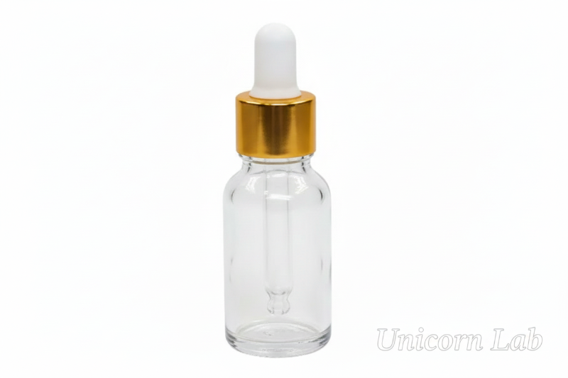 Clear 15ml glass dropper bottle with a gold cap on a white background