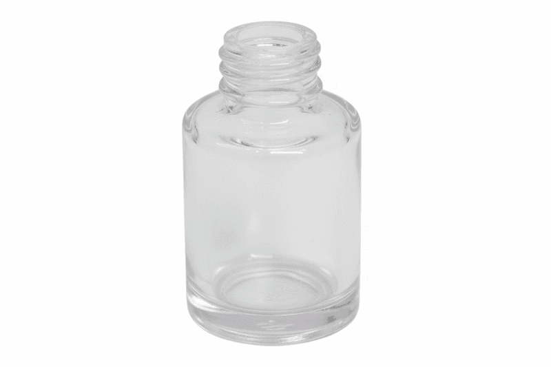 Clear glass bottle on a pink background
