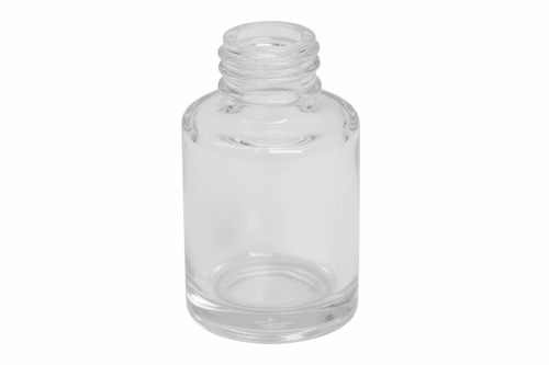 Clear glass bottle on a pink background
