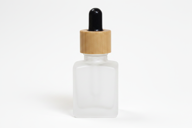 Frosted glass  15ml square dropper bottle with wooden cap on a white background