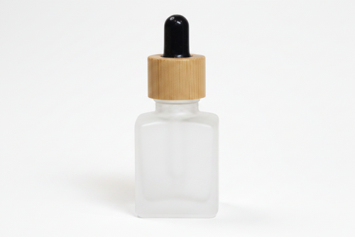 Frosted glass  15ml square dropper bottle with wooden cap on a white background