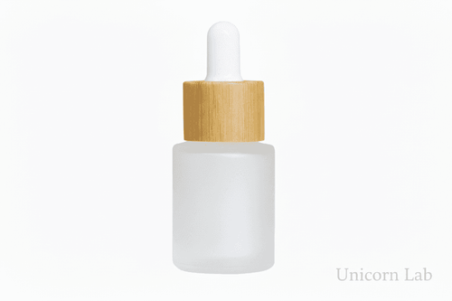 Frosted glass 15ml flat shoulder dropper bottle with wooden cap on a white background