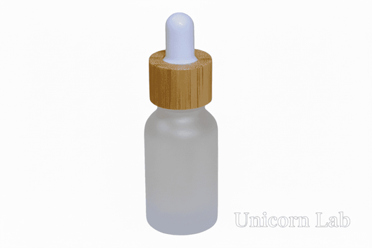 Frosted glass 15ml round dropper bottle with a wooden cap on a white background