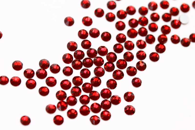 Bulk factory pack of Dark Siam SS6 (2.0mm) deep red glass flatback rhinestones for professional nail art.