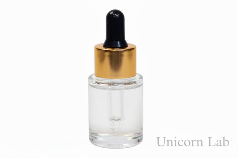 Clear glass dropper bottle with gold cap