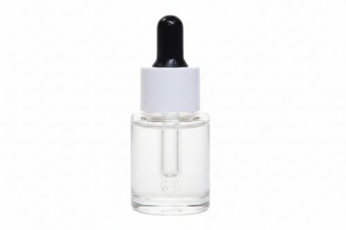Skincare dropper bottle with beige liquid on a white background