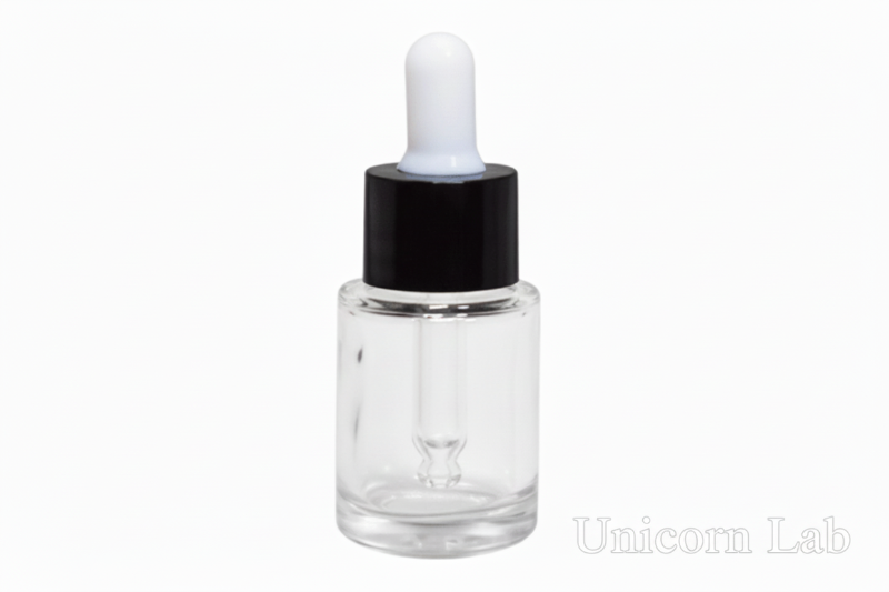 Clear dropper bottle with black cap on a pink background