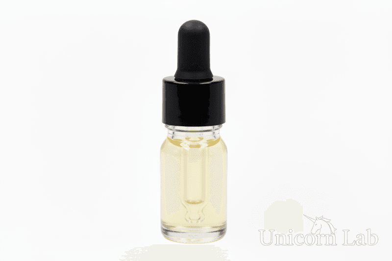 Clear 5ml round dropper bottle with black cap on white background with jojoba oil