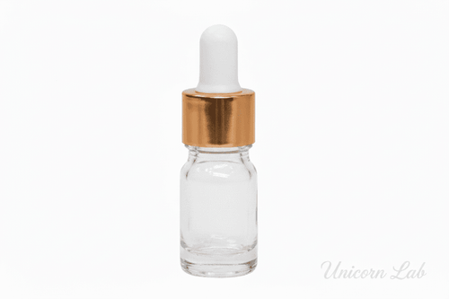 Clear glass 5ml round dropper bottle with a gold cap on a white background
