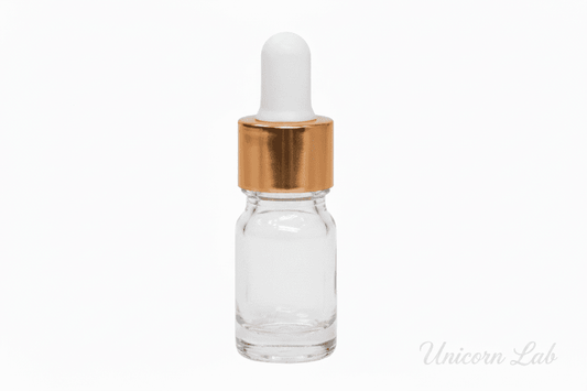 Clear glass 5ml round dropper bottle with a gold cap on a white background