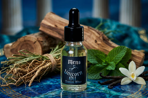 Bottle of 'Mens Unicorn Oil' with natural elements on a decorative surface