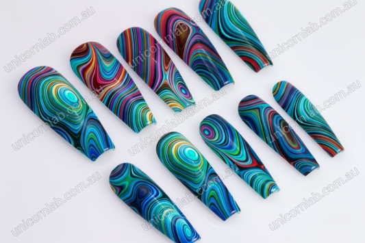 Colorful marbled nail art on long, pointed nails against a white background