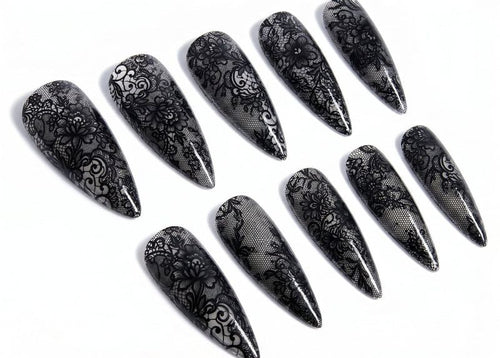 Set of black lace nail art designs on a white background
