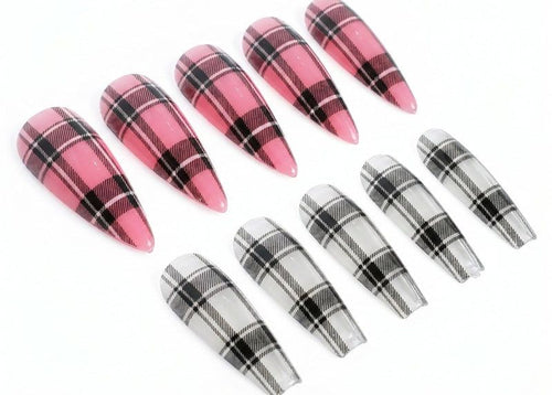 Plaid nail art tips in pink, black, and white on a white background