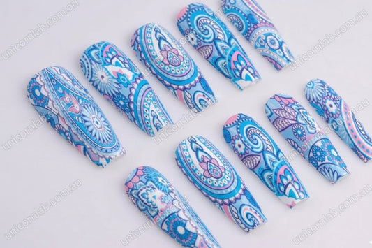 Decorative nail art designs with blue and pink patterns on a white background