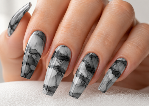 Hand with marble-patterned nails on a neutral background