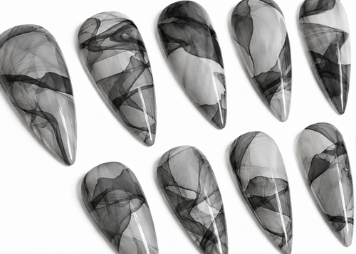 Set of black and white marbled nail art designs on a white background
