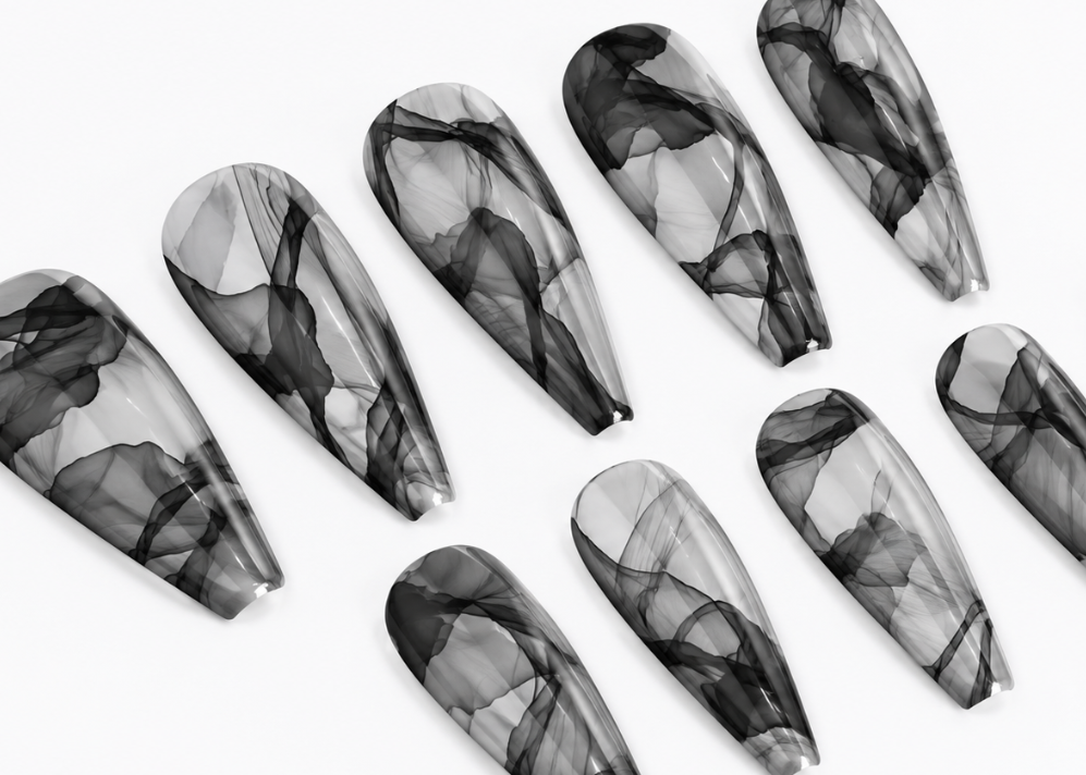 Set of black and gray marbled nail art designs on a white background