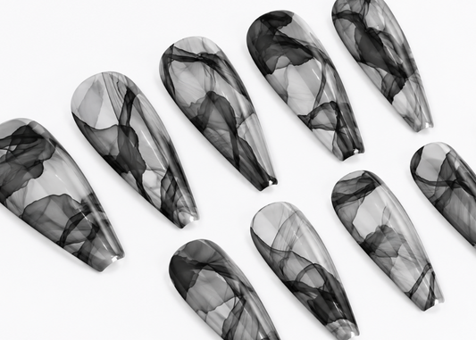 Set of black and gray marbled nail art designs on a white background