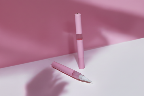 Two pink nail serum pens on a pink background