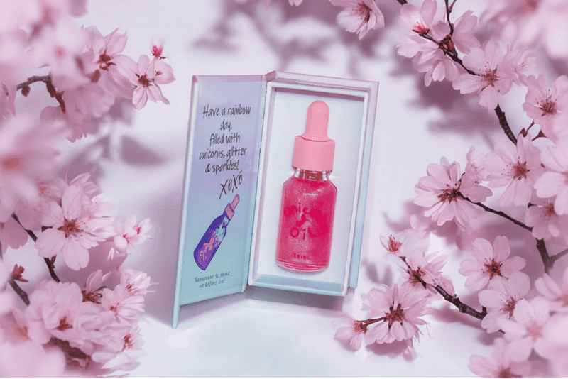 Cherry blossom cuticle oil dropper with clean floral styling, hydrating nail serum