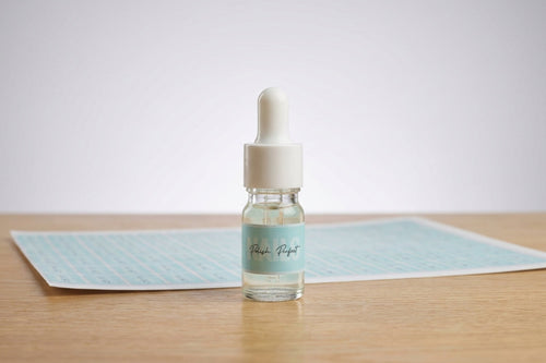Small dropper bottle with a label on a wooden surface