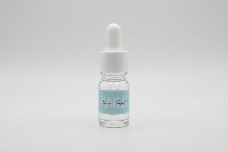 Small glass dropper bottle with a white cap on a light gray background
