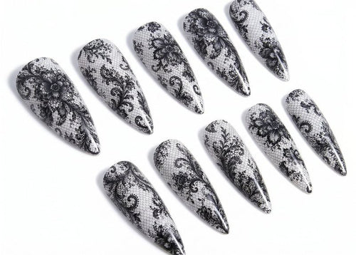 Set of black and white patterned nail art designs on a white background