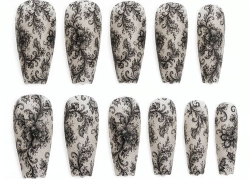 Set of nail wraps with black floral pattern on a white background