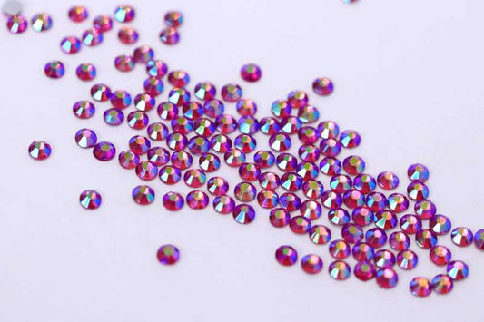 Bulk factory pack of Rose AB SS6 (2.0mm) pink iridescent glass flatback rhinestones for professional nail art.