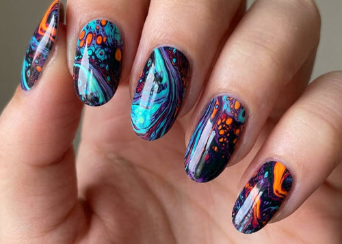 Hand with multicolored nail art on a neutral background