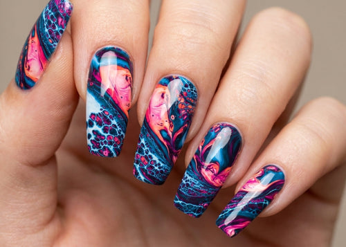 Hand with colorful nail art on a neutral background