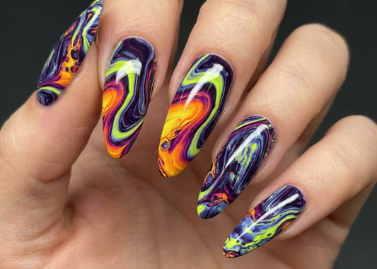 Hand with vibrant, multicolored nail art on a dark background