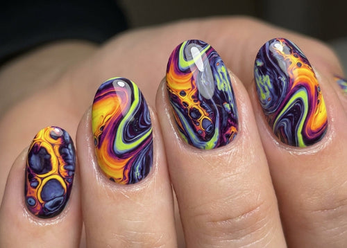 Nails with colorful swirl design on a neutral background