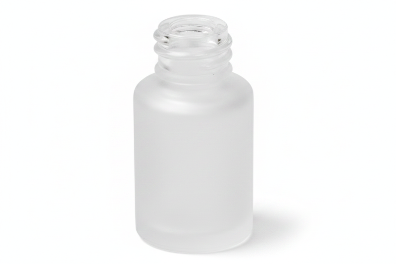 Clear glass bottle with a narrow neck on a pink background