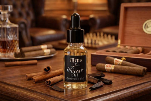 Bottle of 'Mens Unicorn Oil' on a wooden table with cigars and a wooden box in the background.