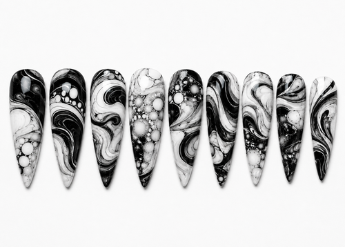 Marbled black and white nail art designs on a white background