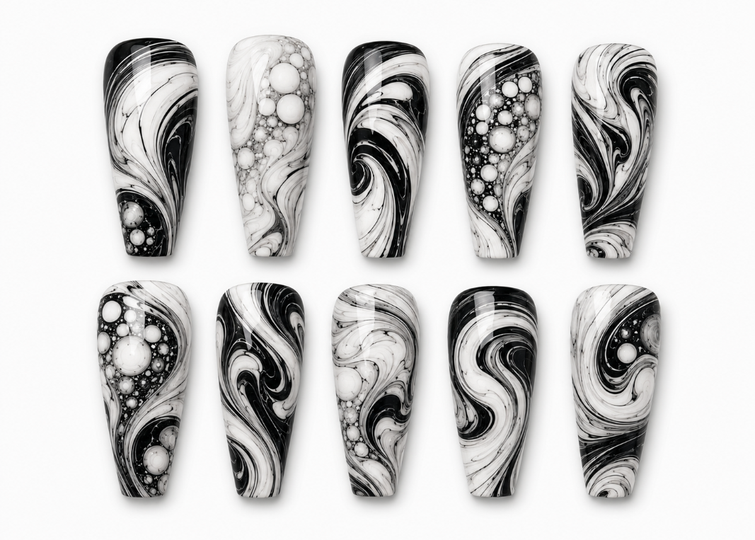 Black and white marbled nail art designs on a white background
