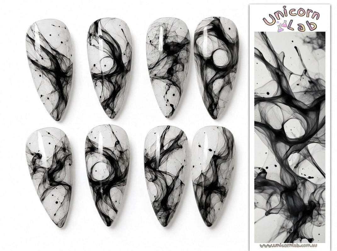 Black and white marbled nail art designs on press-on nails with 'Unicorn XLab' branding.