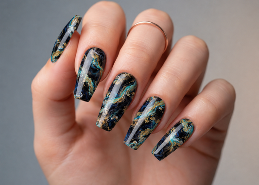 Hand with marbled nail art on a neutral background