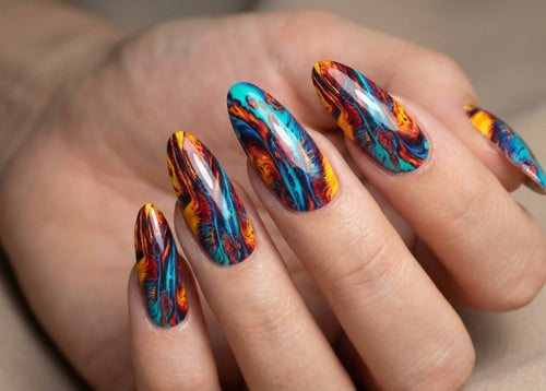 Hand with multicolored flame-style nail art on a neutral background