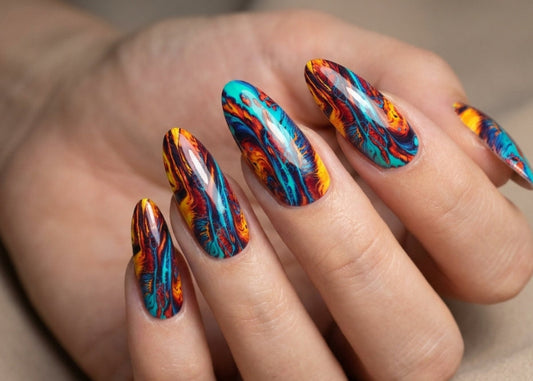Hand with multicolored flame-style nail art on a neutral background