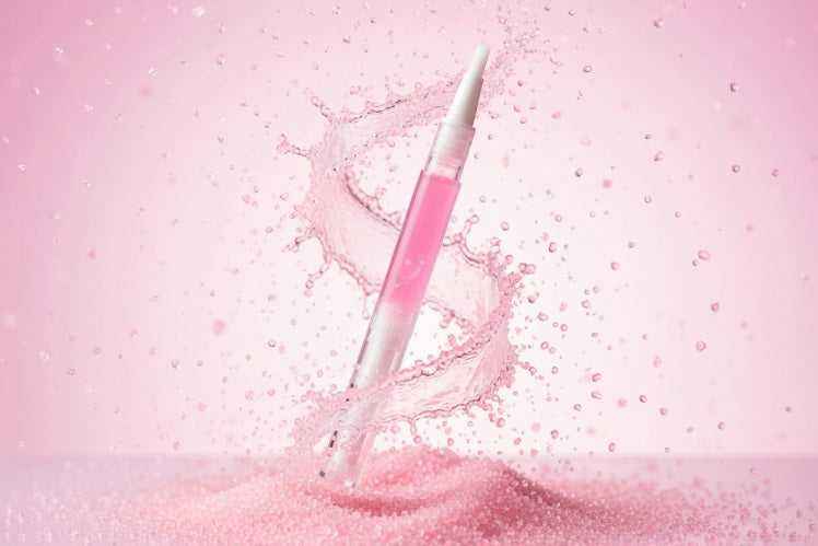 Pink sugar scented cuticle oil pen,  swirling in pink sugar crystals with sparkly nail oil inside. From the sweet tooth unicorn oil range at Unicorn Lab