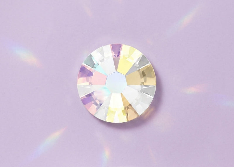 Crystal gemstone on a light purple background. SS10 Crystal AB | Swarovski Crystals