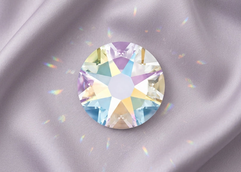 Multicolored gemstone on a gray fabric background. SS12 Crystal AB | Swarovski Crystals